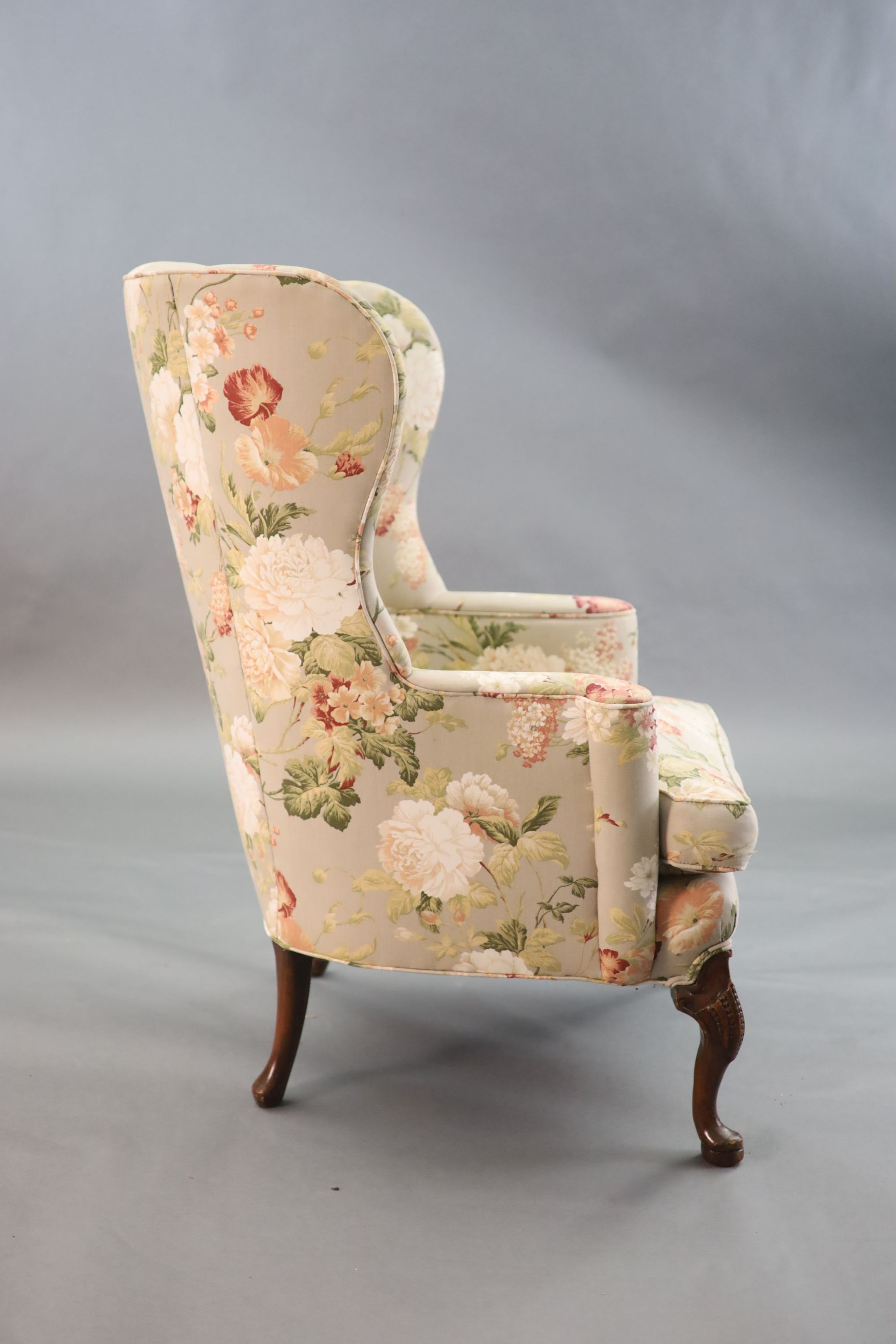 A French Hepplewhite style wing armchair together with a matching contemporary footstool